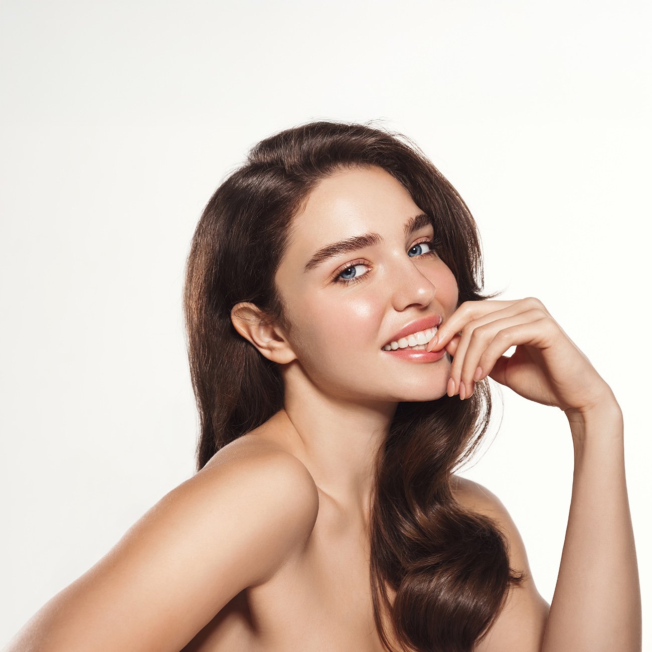 Uśmiechnięta kobieta o promiennej pełnej blasku cerze glass skin