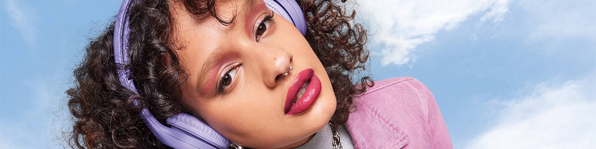 Maybelline Lip Makeup products illustrative banner image - Close up of a blond woman's red lips